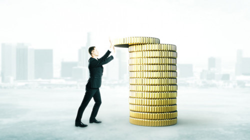 Businessman with coins tower concept