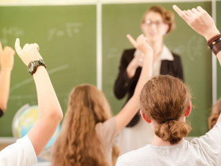 Teacher in a class of pupils in school