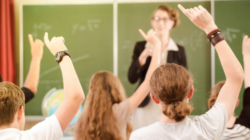 Teacher in a class of pupils in school