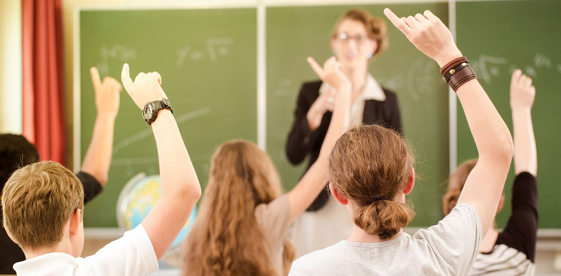 Teacher  in a class of  pupils in school
