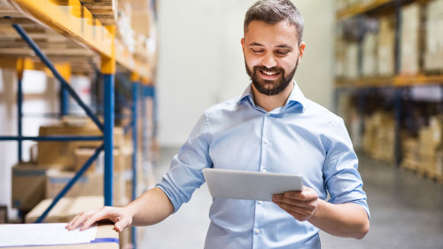 Man warehouse worker with a tablet.