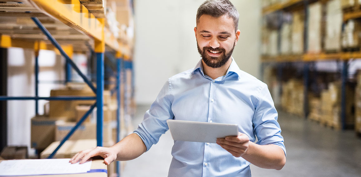 Man warehouse worker with a tablet.
