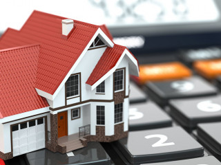 Real estate concept. House on calculator. Mortgage.