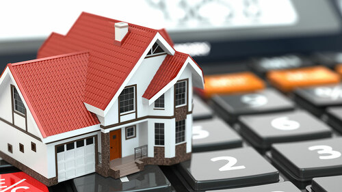 Real estate concept. House on calculator. Mortgage.
