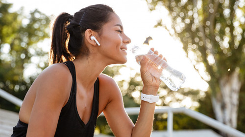 Portrait of a smiling fitness girl in earphones