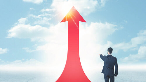 businessman standing on a red arrow