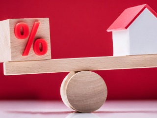 Seesaw Showing Balance Between Percentage Symbol And House Model