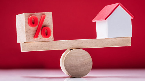 Seesaw Showing Balance Between Percentage Symbol And House Model