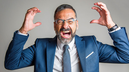 Enraged angry business man yelling and screaming with fury and f