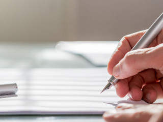 Businessman writing on a document