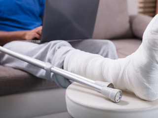 Man With Broken Leg Using Laptop