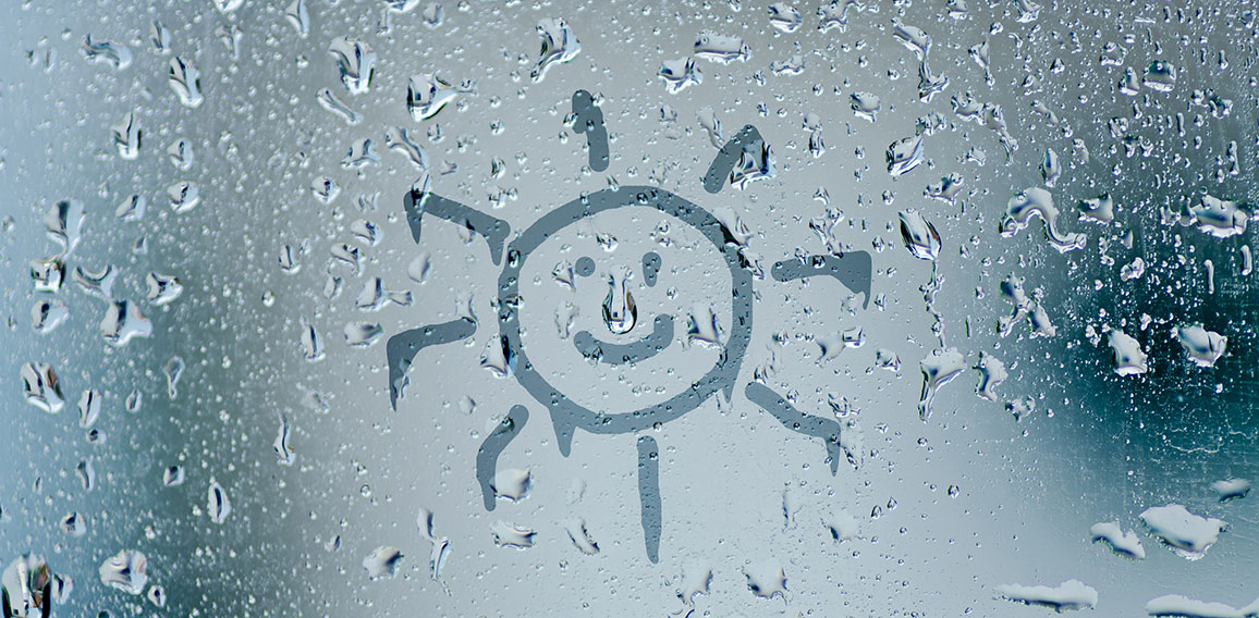 sun sign on natural water drops on glass window background