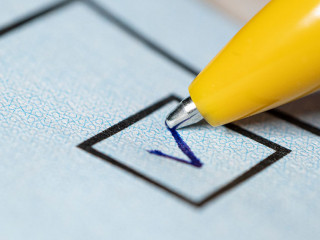 Voting yes or no check-box with fountain pen yes marked with V