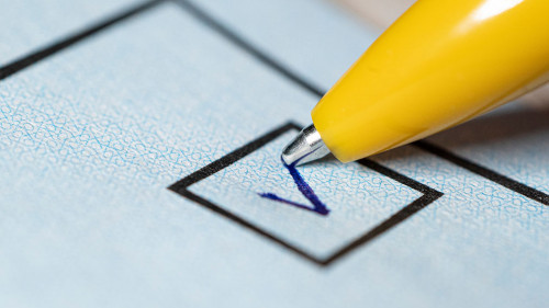 Voting yes or no check-box with fountain pen yes marked with V