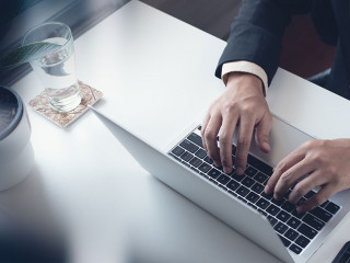 Business man working on laptop computer at modern office. Busine