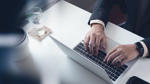 Business man working on laptop computer at modern office. Busine