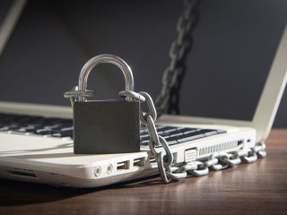 Laptop locked with chains and padlock.