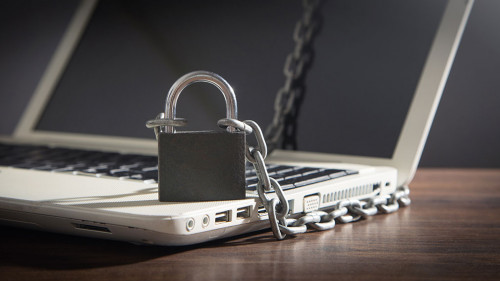 Laptop locked with chains and padlock.
