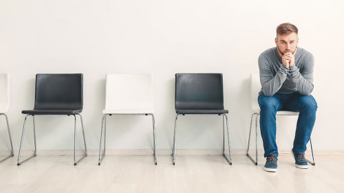 Young man waiting for job interview indoors