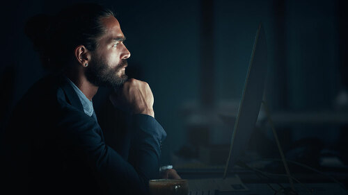 Digital programmer, cyber security and programmer with computer thinking and planning of web design at night. Engineer, developer and man working on ux seo software, database coding and programming