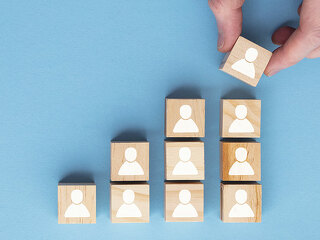 Hand adding a new team member to a group. Business management concept