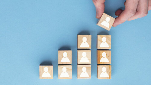 Hand adding a new team member to a group. Business management concept
