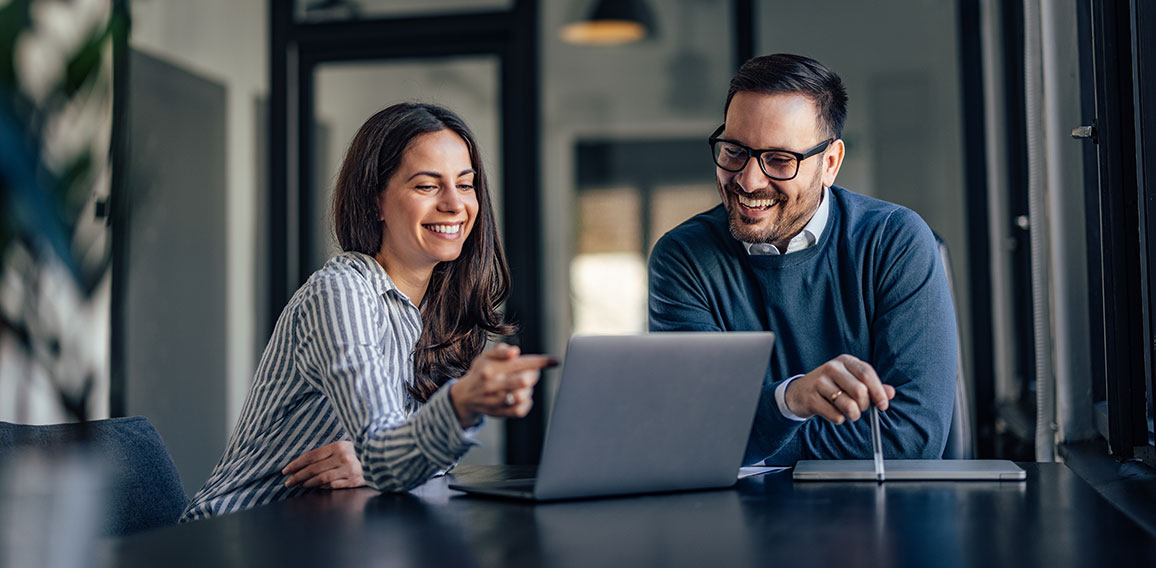 Smiling people, in the meeting room, using a laptop, searching s