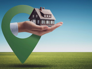 Hand holding a model house