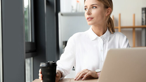 Female business trainer working with laptop in office
