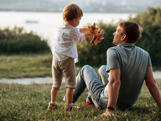 dad and son play on the seashore, vacation with children. Summer adventure, fun trip with kids. Fatherhood, Father's Day. Happy family travel and vacation concept