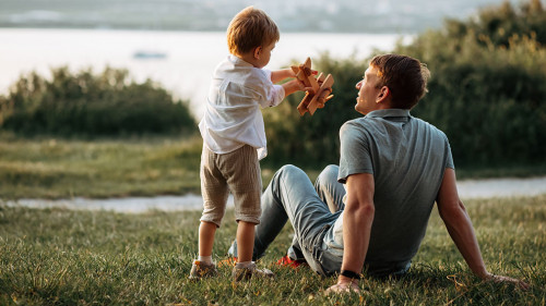 dad and son play on the seashore, vacation with children. Summer adventure, fun trip with kids. Fatherhood, Father's Day. Happy family travel and vacation concept