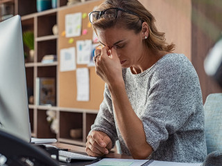 Business woman having headache at office
