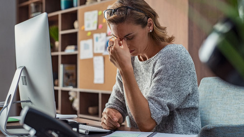 Business woman having headache at office