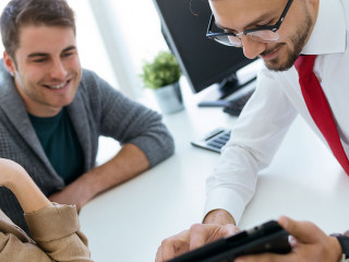 Business man explaining terms of contract to his clients in the