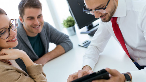 Business man explaining terms of contract to his clients in the