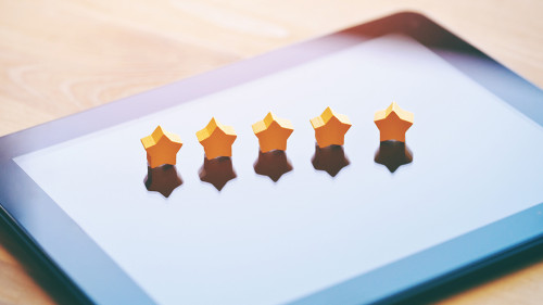 five stars rating symbol as product feedback on tablet computer