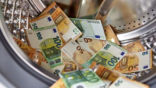 Money laundering concept - euro banknotes in washing machine