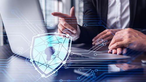 Two business people working on the project to protect cyber security of international company using laptop. Padlock Hologram icons. Teamwork concept.