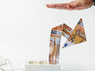 Power strip with rising arrow made of euro banknotes, hand from