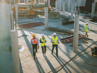 Diverse Team of Specialists Taking a Walk Through Construction S