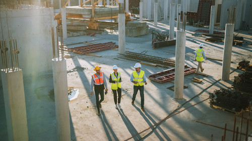 Diverse Team of Specialists Taking a Walk Through Construction S