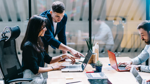 Proud ceo pointing on laptop computer and discussing graphic pre