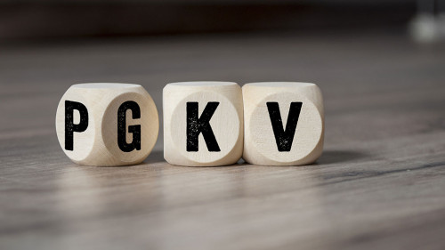 Cubes and dice with the acronyms PKV and GKV on wooden backgroun