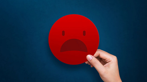 Customer giving bad emoticon for rating on blue background. Serv