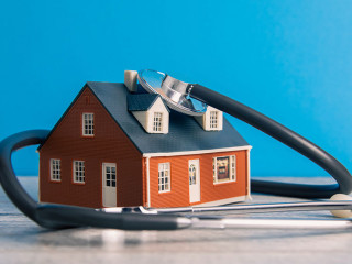House and Stethoscope on Table
