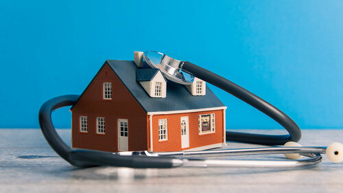 House and Stethoscope on Table
