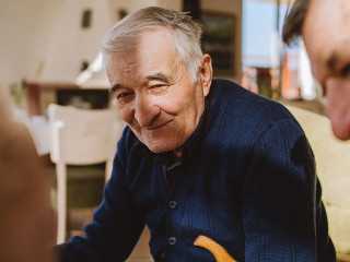 Portrait of senior man 80 years old pensioner sitting in chair w