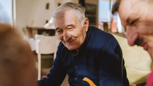 Portrait of senior man 80 years old pensioner sitting in chair w