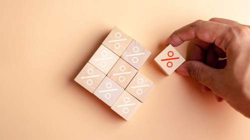 Percentage sign of hand arranging wood blocks stacking as step stair with percent symbol, interest rate and business profit growth concept.