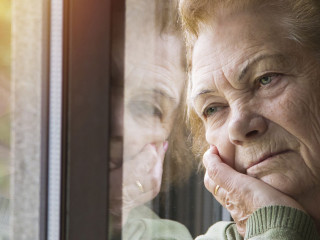 portrait of senior woman looking out the window